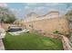 Expansive backyard offering a lush lawn, lounge area, and a rejuvenating hot tub at 8890 Bonneville Peak Ct, Las Vegas, NV 89148