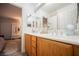 Bright bathroom featuring a white countertop with double sinks and wood cabinets at 8890 Bonneville Peak Ct, Las Vegas, NV 89148