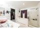 Bathroom boasting walk-in shower, soaker tub and view to the closet, all with floral wallpaper at 8890 Bonneville Peak Ct, Las Vegas, NV 89148