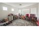 This bedroom has multiple windows and features a variety of toys, shelving, and a patterned area rug at 8890 Bonneville Peak Ct, Las Vegas, NV 89148