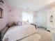 Charming bedroom with a cozy daybed, rocking chair, and soft pink walls, creating a serene space at 8890 Bonneville Peak Ct, Las Vegas, NV 89148