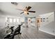 Bright bonus room with wood floors, ceiling fan, storage cabinets, and staircase at 8890 Bonneville Peak Ct, Las Vegas, NV 89148