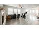 Spacious bonus room with wood floors, large windows, desk, and exercise bike at 8890 Bonneville Peak Ct, Las Vegas, NV 89148