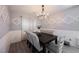Dining room featuring a dark wood table, upholstered chairs, decorative wall panels, and a modern chandelier at 8890 Bonneville Peak Ct, Las Vegas, NV 89148
