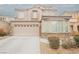 Two-story home featuring a two-car garage and stone accents, set in a well-maintained community at 8890 Bonneville Peak Ct, Las Vegas, NV 89148