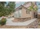 Two-story house with a stone facade on the lower level and a well-manicured lawn at 8890 Bonneville Peak Ct, Las Vegas, NV 89148