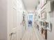 Hallway featuring wood-look tile, decorated with personal pictures and modern lighting at 8890 Bonneville Peak Ct, Las Vegas, NV 89148