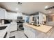 Bright open kitchen with stainless steel appliances, white cabinetry, an island, and a view into the dining area at 8890 Bonneville Peak Ct, Las Vegas, NV 89148