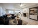 Bright living room with a fireplace, an open layout and views of the modern kitchen at 8890 Bonneville Peak Ct, Las Vegas, NV 89148