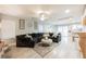 Open living room with a large sofa, stylish decor, and a view of the modern kitchen at 8890 Bonneville Peak Ct, Las Vegas, NV 89148