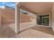 Back patio showing the stucco house, brick-paved patio, and a retaining wall at 8979 Rolling Pietra St, Las Vegas, NV 89166