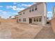 The backyard features a stucco house, a rock yard, and a block fence at 8979 Rolling Pietra St, Las Vegas, NV 89166