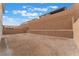 The backyard has a retaining wall and is ready for landscaping at 8979 Rolling Pietra St, Las Vegas, NV 89166