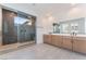 Beautiful bathroom featuring glass shower enclosure, double sink vanity, and neutral tile at 8979 Rolling Pietra St, Las Vegas, NV 89166