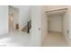 Hallway featuring tile flooring, staircase, and access to other rooms in the home at 8979 Rolling Pietra St, Las Vegas, NV 89166