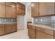 Spacious kitchen featuring custom cabinetry, stone countertops, and stainless steel appliances at 8979 Rolling Pietra St, Las Vegas, NV 89166