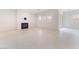 Bright living room with white tile flooring, a modern fireplace, and shuttered windows, offering a clean and inviting space at 8979 Rolling Pietra St, Las Vegas, NV 89166