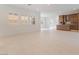 Bright living room featuring tile flooring, plantation shutters, and a glimpse of the kitchen at 8979 Rolling Pietra St, Las Vegas, NV 89166