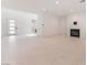 Spacious living area with tile floors, a fireplace, and ample natural light, creating a bright and welcoming atmosphere at 8979 Rolling Pietra St, Las Vegas, NV 89166