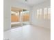 Bright room with sliding glass doors to patio and shuttered windows providing an abundance of natural light at 8979 Rolling Pietra St, Las Vegas, NV 89166