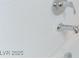 Close-up of a chrome shower head and faucet with white tiled shower walls at 8979 Rolling Pietra St, Las Vegas, NV 89166
