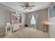 Bedroom is a cozy retreat with a ceiling fan, large window, and space for a study area at 9180 Wine Cellar Ave, Las Vegas, NV 89148