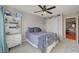 Bedroom features a large window with curtains, ceiling fan, and a comfortable bed at 9180 Wine Cellar Ave, Las Vegas, NV 89148