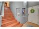 Foyer with wood stairs, tiled floor, arched art niche, and door to the garage at 9180 Wine Cellar Ave, Las Vegas, NV 89148