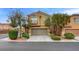 Charming two-story home with a two-car garage, mature landscaping, and a welcoming facade at 9180 Wine Cellar Ave, Las Vegas, NV 89148