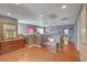 Open hallway featuring hardwood floors, vintage chest, and access to multiple rooms at 9180 Wine Cellar Ave, Las Vegas, NV 89148