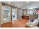 Hallway featuring hardwood floors, an antique dresser, and access to multiple rooms at 9180 Wine Cellar Ave, Las Vegas, NV 89148