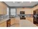 Bright kitchen featuring wooden cabinets and modern appliances at 9180 Wine Cellar Ave, Las Vegas, NV 89148