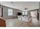 Bright living room with wood floors, a ceiling fan, and sliding glass doors at 9180 Wine Cellar Ave, Las Vegas, NV 89148