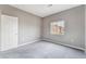 Bedroom featuring neutral carpet and soft grey walls with natural light from a window at 9303 Gilcrease Ave # 1013, Las Vegas, NV 89149