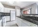 A spacious kitchen with white cabinetry, granite countertops, and a stainless steel sink at 9303 Gilcrease Ave # 1013, Las Vegas, NV 89149