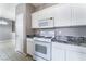Well-lit kitchen features white cabinetry, black granite countertops, and modern appliances at 9303 Gilcrease Ave # 1013, Las Vegas, NV 89149