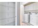 Functional laundry room with washer, dryer, shelving, and white cabinets at 9303 Gilcrease Ave # 1013, Las Vegas, NV 89149