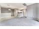 Open-concept living area with neutral tones and tile flooring transition at 9303 Gilcrease Ave # 1013, Las Vegas, NV 89149