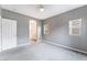 Bright main bedroom with soft carpet, neutral walls, and ensuite bathroom entrance at 9303 Gilcrease Ave # 1013, Las Vegas, NV 89149
