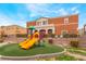 Colorful community playground with slides and an artificial lawn at 9303 Gilcrease Ave # 1013, Las Vegas, NV 89149