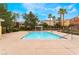 Community pool area with palm trees and seating, perfect for relaxation at 9303 Gilcrease Ave # 1013, Las Vegas, NV 89149