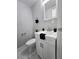 Powder room features a modern white vanity, faucet, mirror, and commode at 1021 Wengert Ave, Las Vegas, NV 89104