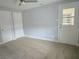 Bedroom featuring neutral carpeting and a door to the backyard at 1021 Wengert Ave, Las Vegas, NV 89104