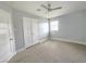 Neutral bedroom featuring carpet, ceiling fan, window and a closet with double doors at 1021 Wengert Ave, Las Vegas, NV 89104