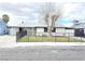 Charming single-story home featuring a fenced front yard with low maintenance landscaping and a gray exterior at 1021 Wengert Ave, Las Vegas, NV 89104