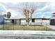 Charming single-story home featuring a well-manicured lawn and decorative wrought iron fence at 1021 Wengert Ave, Las Vegas, NV 89104