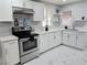 Bright kitchen featuring stainless steel appliances, modern countertops, white cabinets, and tiled flooring at 1021 Wengert Ave, Las Vegas, NV 89104