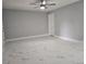 Spacious living room with tiled flooring, neutral walls, ceiling fan, and a door leading to another room at 1021 Wengert Ave, Las Vegas, NV 89104