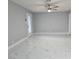 Spacious living room with tiled flooring, neutral walls, ceiling fan, and a glass door leading to the exterior at 1021 Wengert Ave, Las Vegas, NV 89104