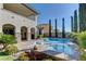 Relaxing backyard featuring a sparkling pool and patio with the luxury home in the background at 12121 Cabo Rojo Ave, Las Vegas, NV 89138